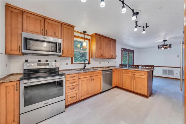 a view of a livingroom with furniture and a window