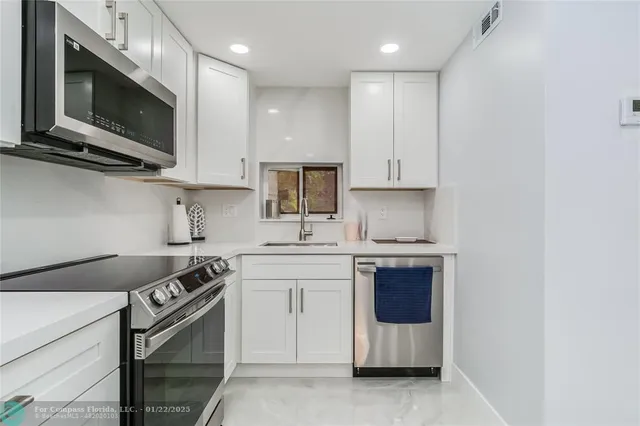 a kitchen with stainless steel appliances granite countertop a stove and a microwave