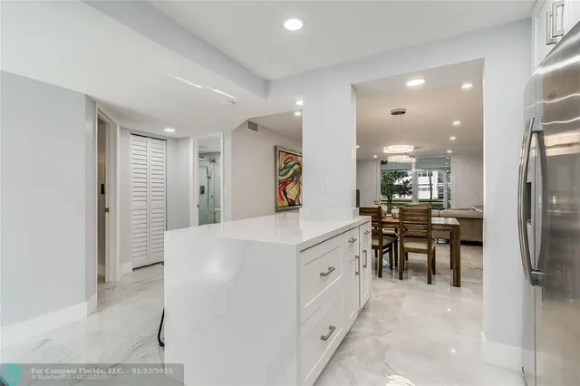 a kitchen with kitchen island a sink appliances and a counter top space