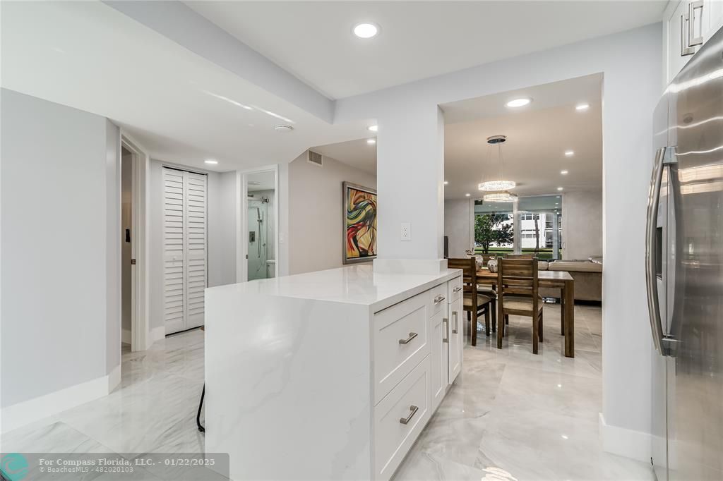 9523 South Hollybrook Lake Drive, Unit 102 Pembroke Pines, FL 33025 - Photo 14 of 63 a kitchen with kitchen island a sink appliances and a counter top space