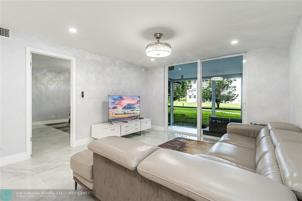 9523 South Hollybrook Lake Drive, Unit 102 Pembroke Pines, FL 33025 - Photo 16 of 63 a living room with furniture a window and a flat screen tv