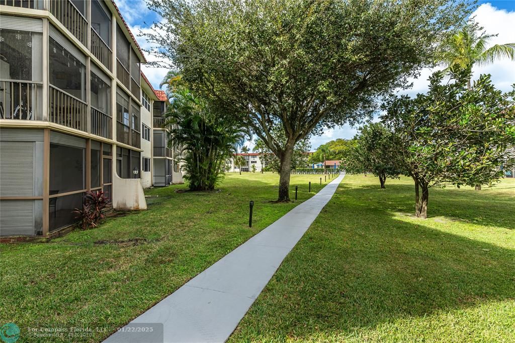 9523 South Hollybrook Lake Drive, Unit 102 Pembroke Pines, FL 33025 - Photo 22 of 63 a view of a park with large trees