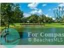 9523 South Hollybrook Lake Drive, Unit 102 Pembroke Pines, FL 33025 - Photo 26 of 63 a view of a golf course with a lake in back