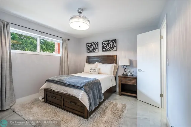 a bedroom with a bed and window