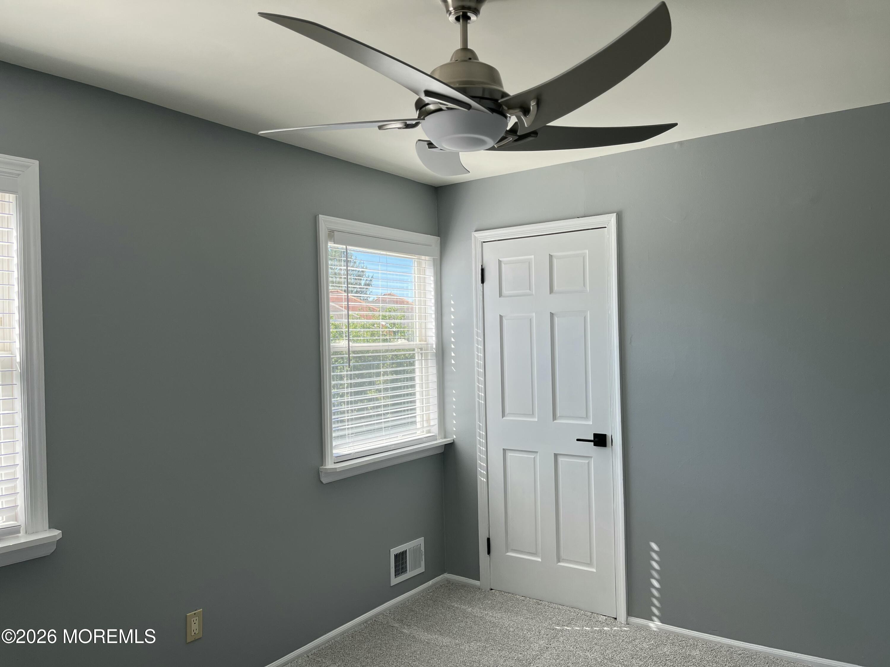 53 Primrose Lane Brick, NJ 08724 - Photo 12 of 17 a view of a livingroom with a window and a ceiling fan
