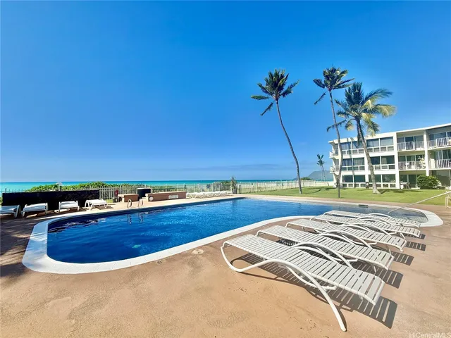 a view of a swimming pool and a yard