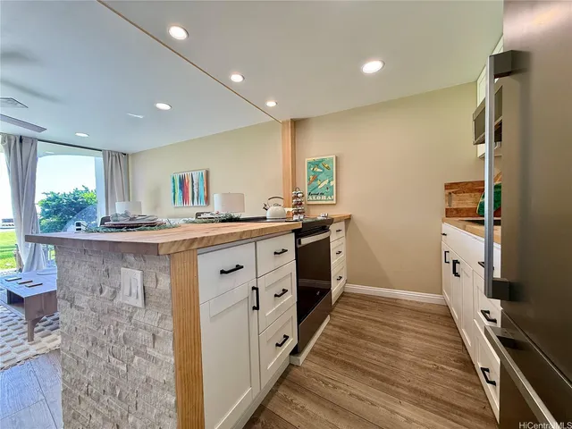 a kitchen with stainless steel appliances a sink stove and refrigerator