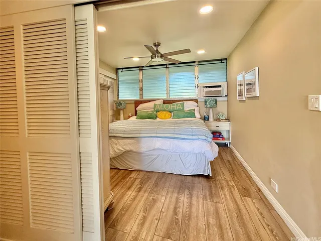 a bedroom with a bed and wooden floor