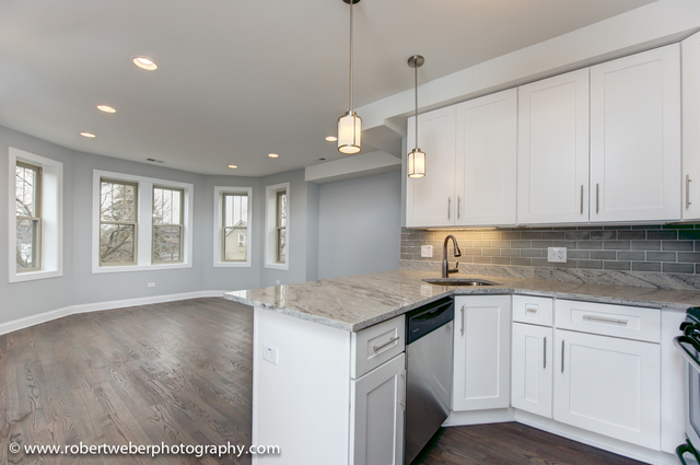 2329 West Barry Avenue, Unit 2 Chicago, IL 60618 - Photo 3 of 10 a kitchen with white cabinets and sink