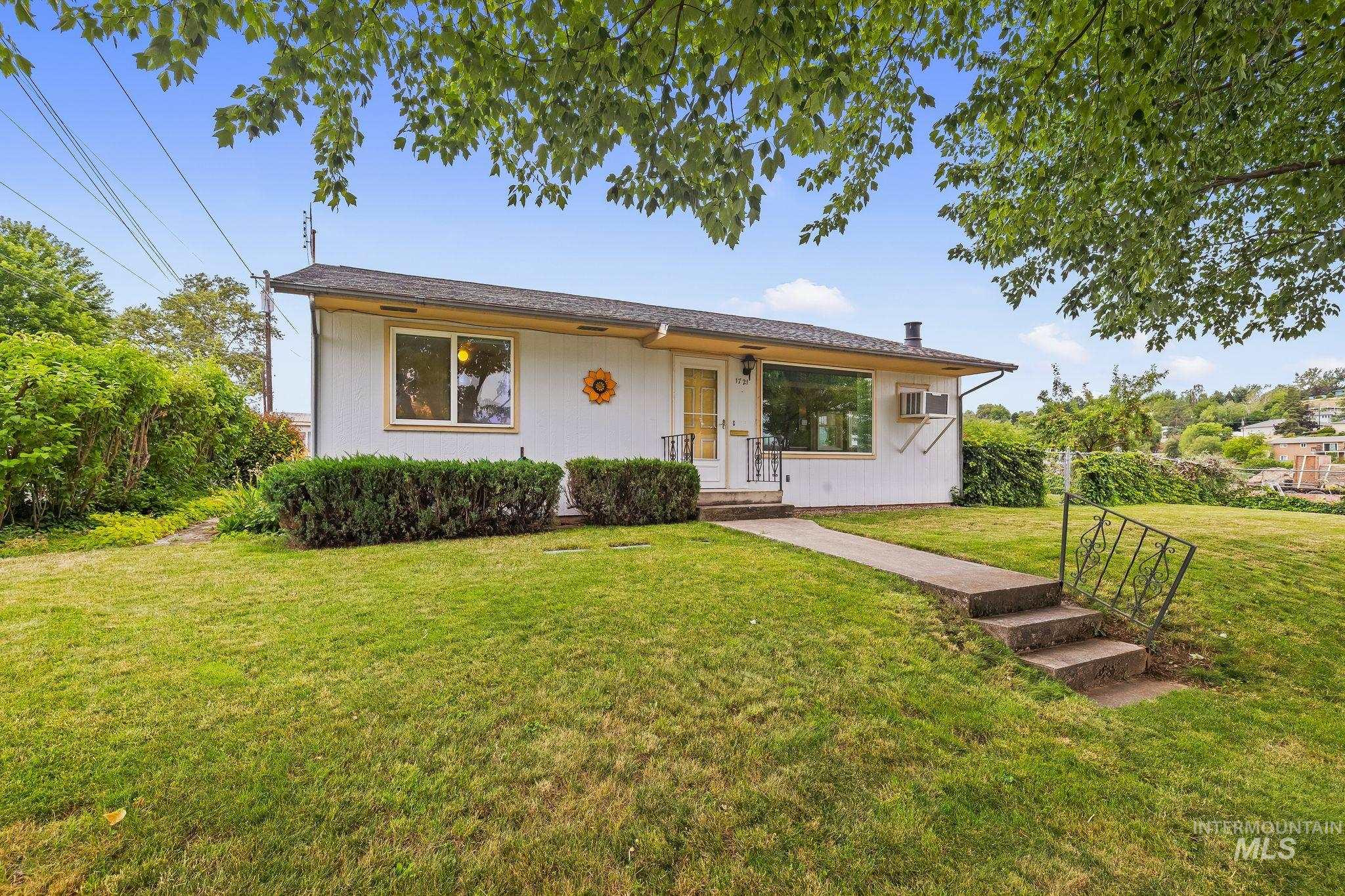 1721 3rd Street Lewiston, ID 83501 - Photo 16 of 45 White exterior with a dark roof and light yellow trim