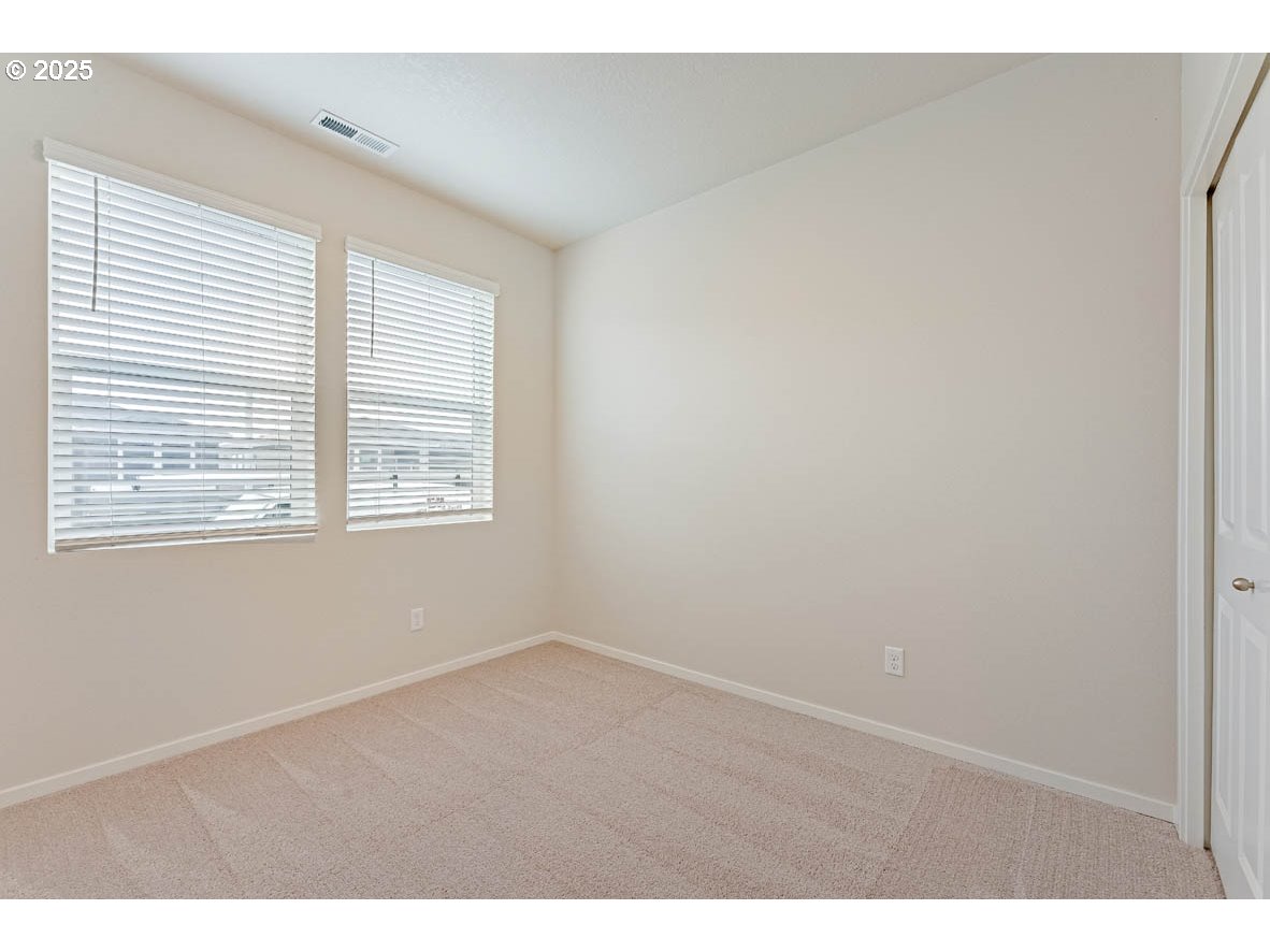 2963 U Street Springfield, OR 97477 - Photo 4 of 26 a view of an empty room with wooden floor and a window