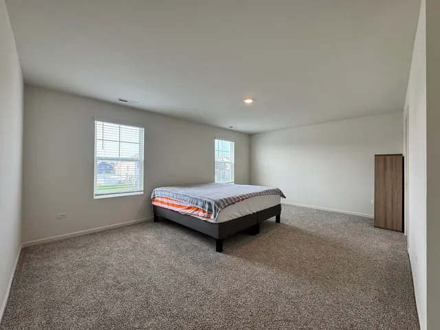 a bedroom with a bed table and window