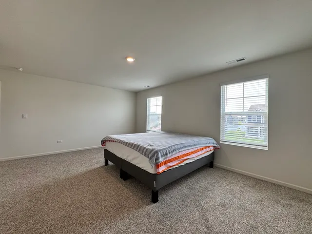 a room with a bed and window