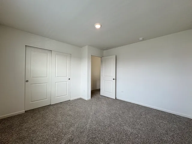 a view of an empty room and closet area