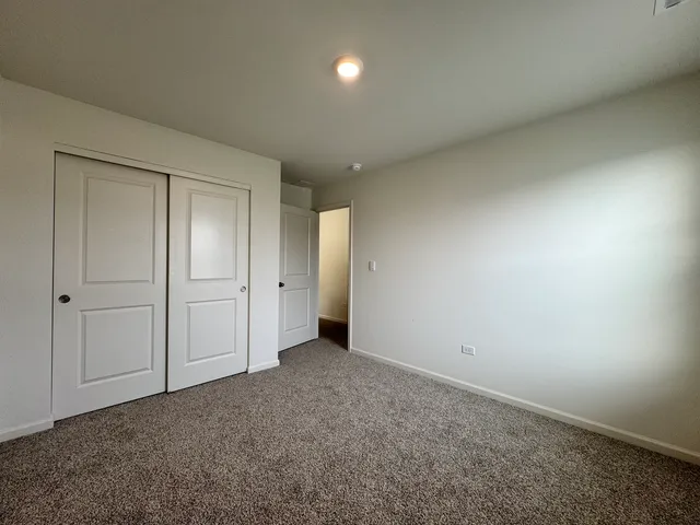 an empty room with closet area