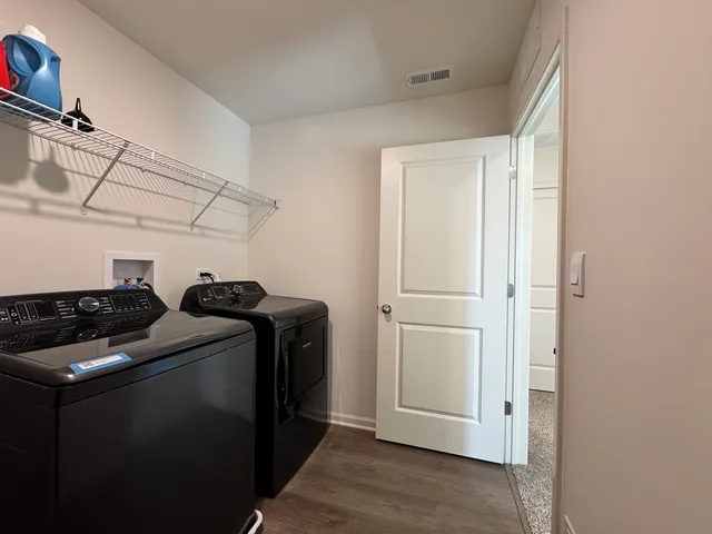 a view of storage and utility room with washer and dryer