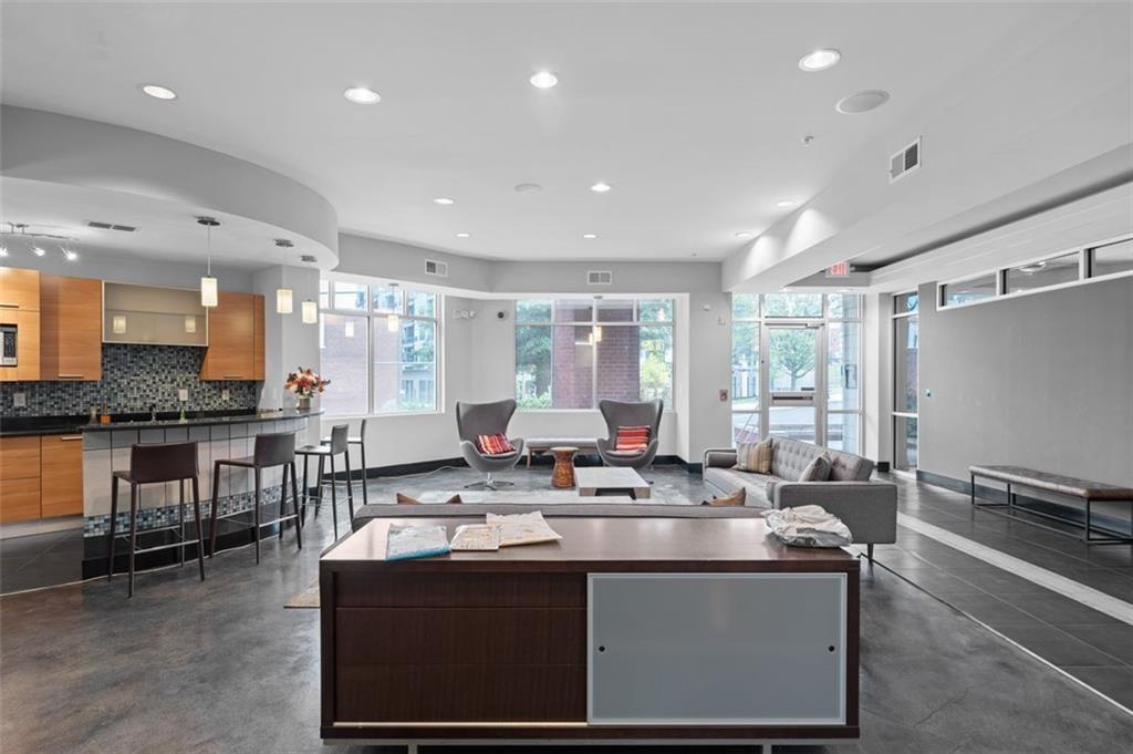 89 Mangum Street Southwest, Unit 207 Atlanta, GA 30313 - Photo 5 of 23 a kitchen with stainless steel appliances granite countertop a sink a stove and a refrigerator