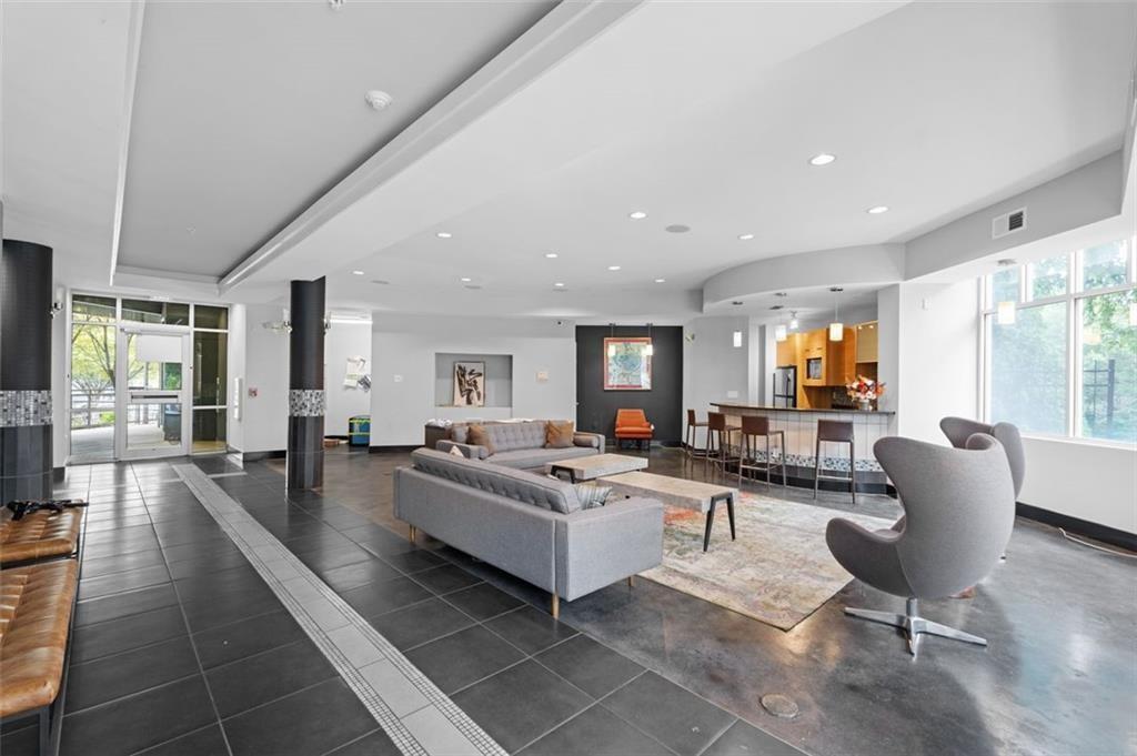 89 Mangum Street Southwest, Unit 207 Atlanta, GA 30313 - Photo 6 of 23 a living room with furniture and a large window