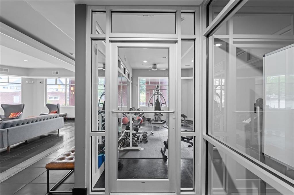 89 Mangum Street Southwest, Unit 207 Atlanta, GA 30313 - Photo 7 of 23 a bathroom with a glass shower door and a bathtub
