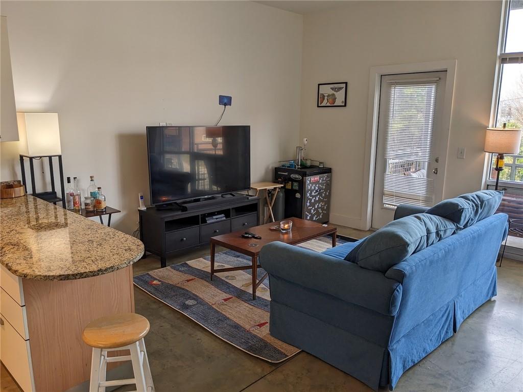 89 Mangum Street Southwest, Unit 207 Atlanta, GA 30313 - Photo 9 of 23 a living room with furniture and a flat screen tv