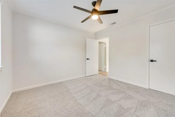 an empty room with fan and a ceiling fan