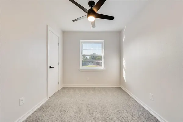 a view of room with window and ceiling fan
