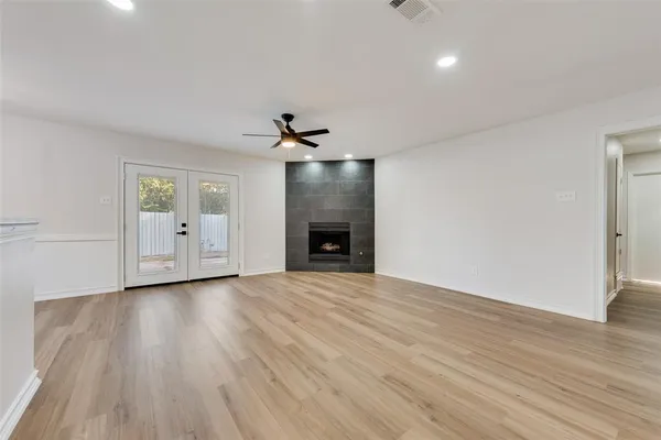 wooden floor in an empty room with a fireplace