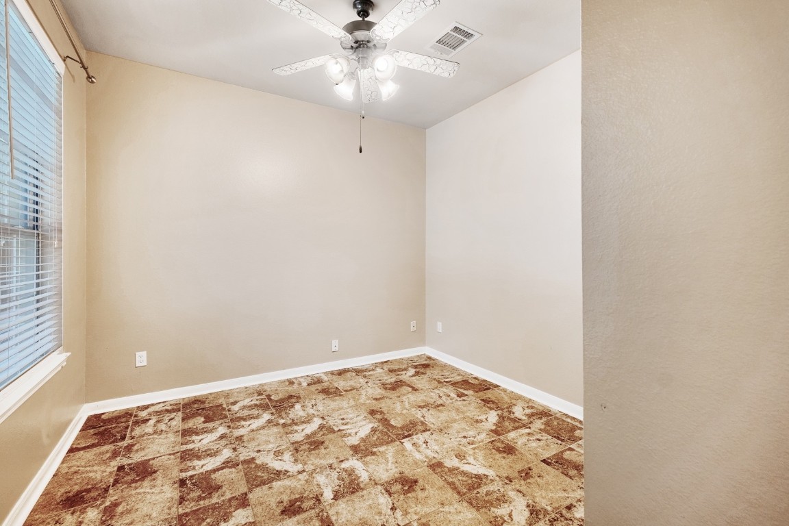 30103 Wingfoot Cove Georgetown, TX 78628 - Photo 18 of 38 an empty room with a window and ceiling fan