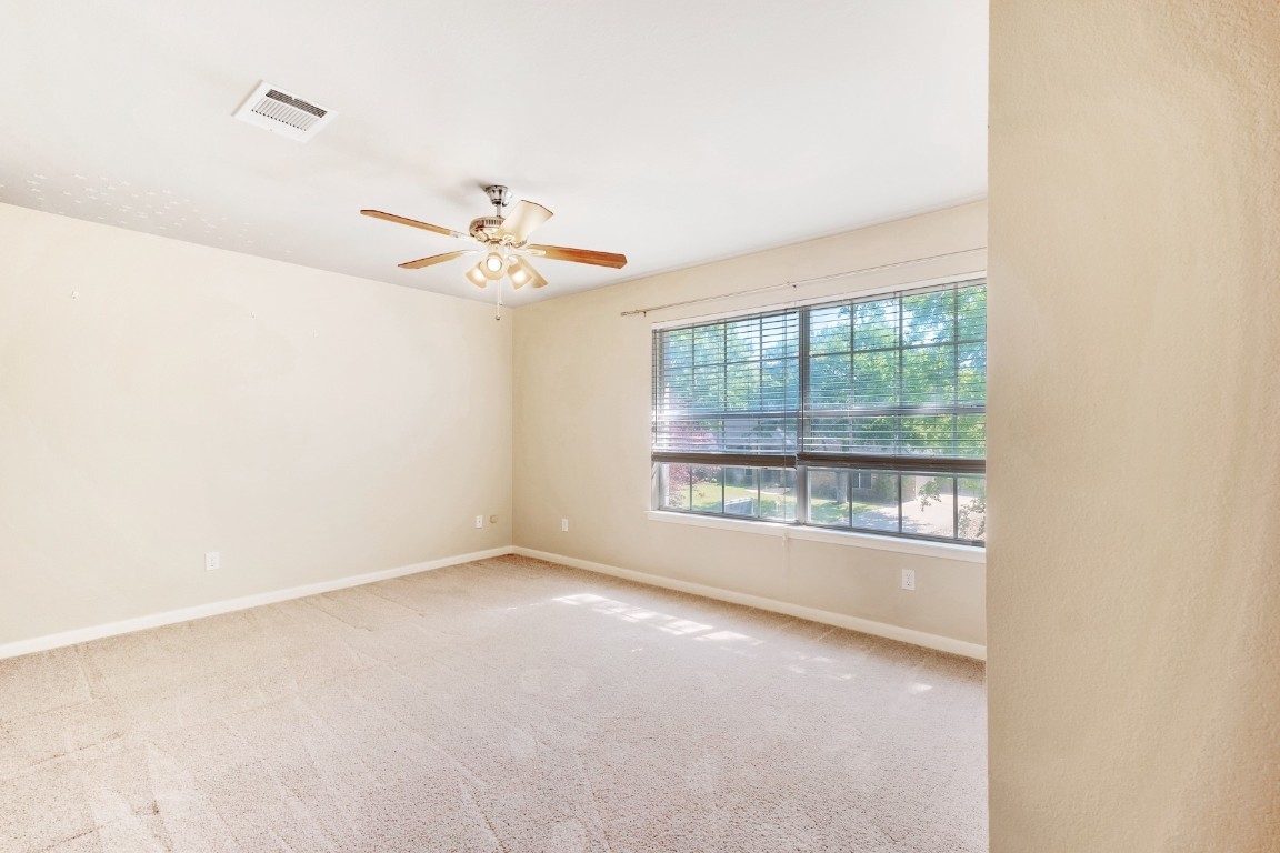 30103 Wingfoot Cove Georgetown, TX 78628 - Photo 23 of 38 an empty room with a window and a ceiling fan