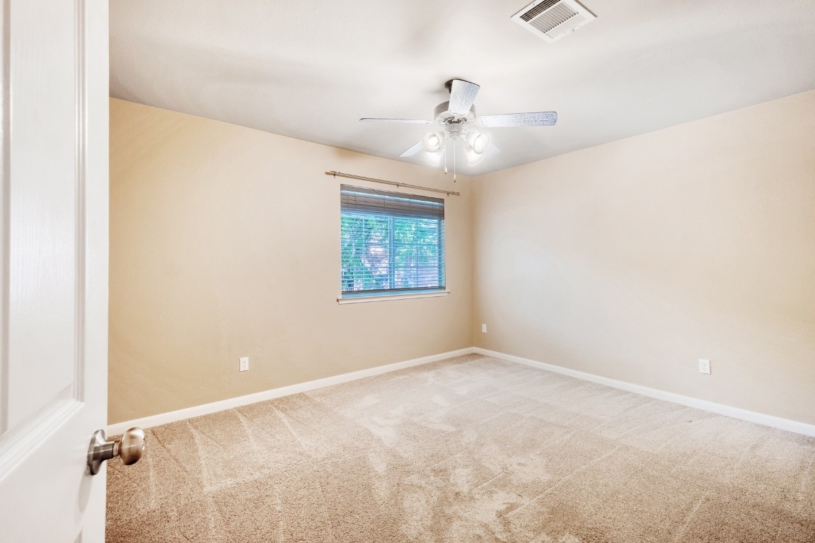 30103 Wingfoot Cove Georgetown, TX 78628 - Photo 26 of 38 an empty room with windows and fan