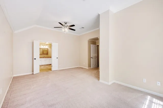 an empty room with fan and entrance