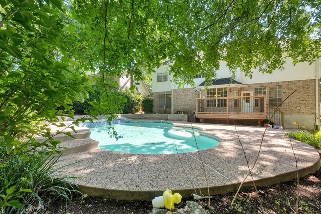 swimming pool view with a seating space