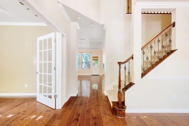 a view of entryway with wooden floor and stairs