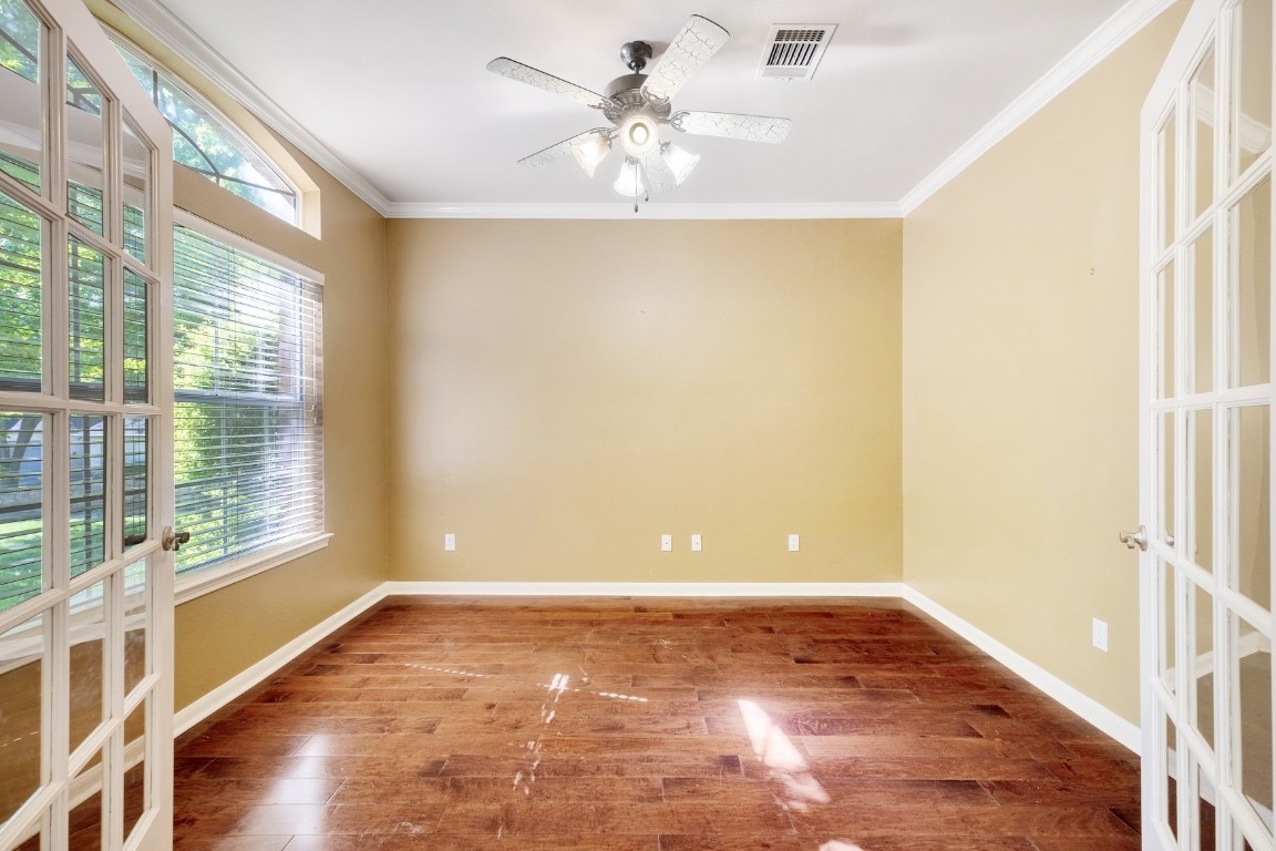 30103 Wingfoot Cove Georgetown, TX 78628 - Photo 6 of 38 a view of an empty room with a window and wooden floor