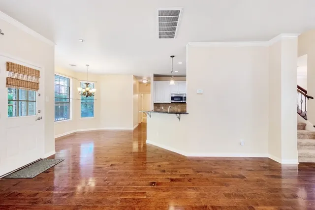 a view of kitchen and hall with wooden floor