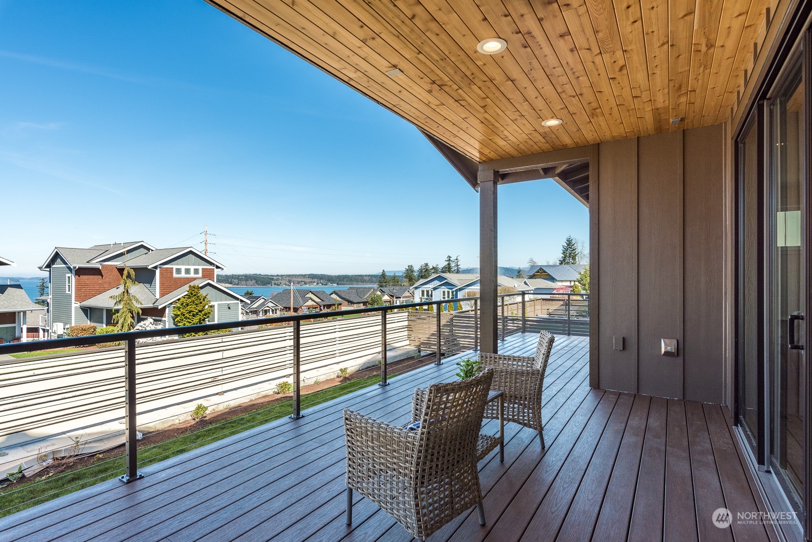 3908 West 3rd Street Anacortes, WA 98221 - Photo 32 of 39 a view of a balcony with furniture and wooden floor