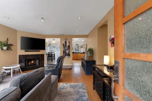 a living room with fireplace furniture and a flat screen tv