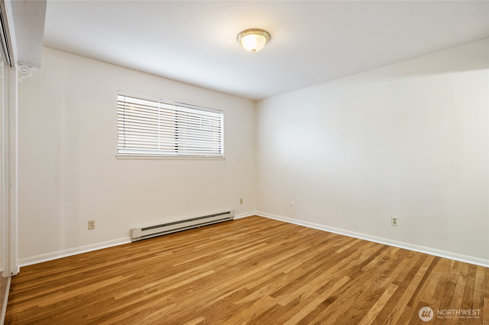 2014 Southwest 152nd Street Burien, WA 98166 - Photo 21 of 28 an empty room with wooden floor and windows