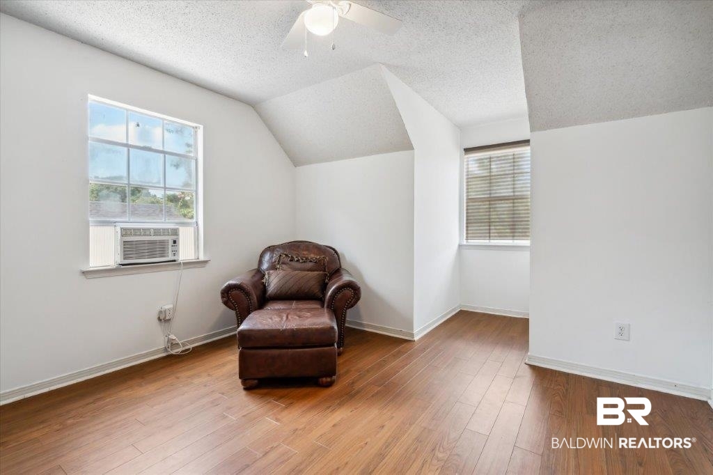 3616 Vista Ridge Drive Mobile, AL 36693 - Photo 14 of 20 Sitting room with lofted ceiling, a textured ceiling, ceiling fan, hardwood / wood-style flooring, and cooling unit
