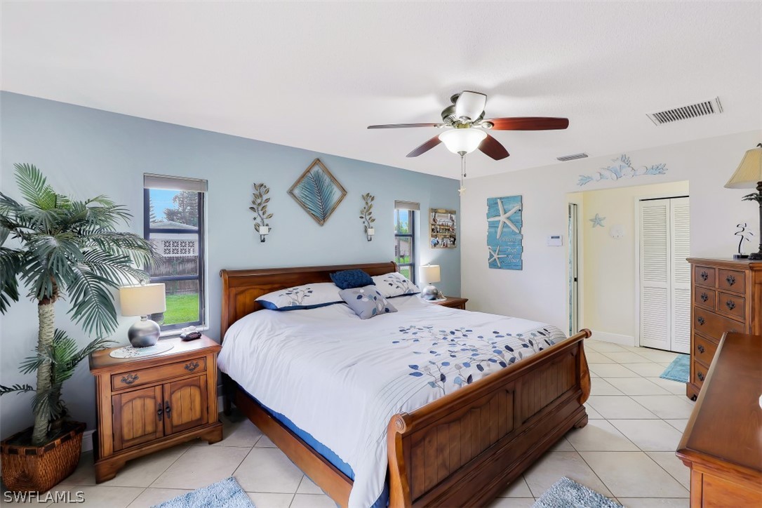 18507 Evergreen Road Fort Myers, FL 33967 - Photo 15 of 33 a bedroom with a large bed and a chandelier