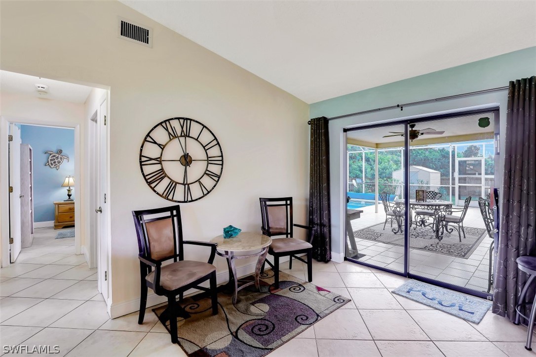 18507 Evergreen Road Fort Myers, FL 33967 - Photo 3 of 33 a dining room with furniture and a floor to ceiling window
