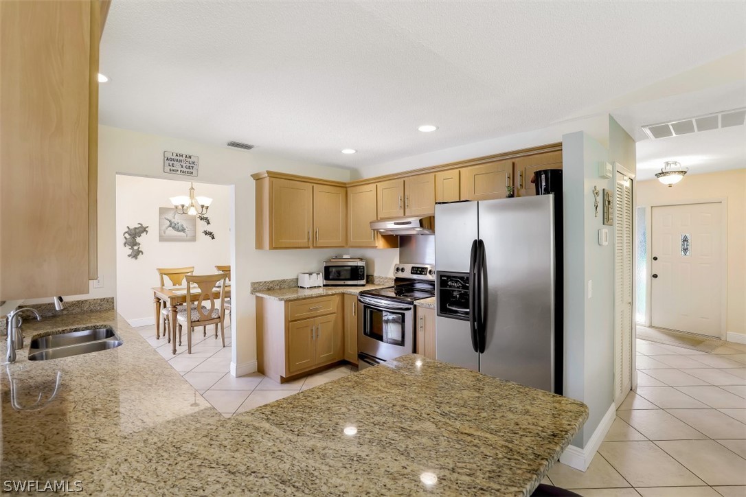 18507 Evergreen Road Fort Myers, FL 33967 - Photo 5 of 33 a kitchen with stainless steel appliances granite countertop a refrigerator and a stove top oven