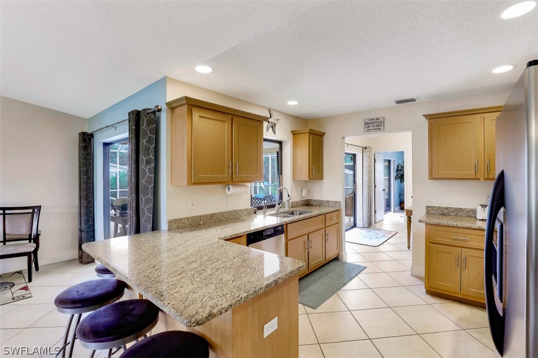 18507 Evergreen Road Fort Myers, FL 33967 - Photo 6 of 33 a kitchen with granite countertop sink stove and cabinets