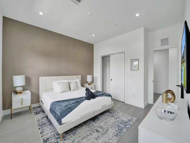 a bedroom with a bed and a couch