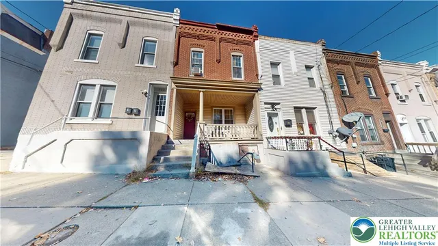 a front view of a house with wooden stairs