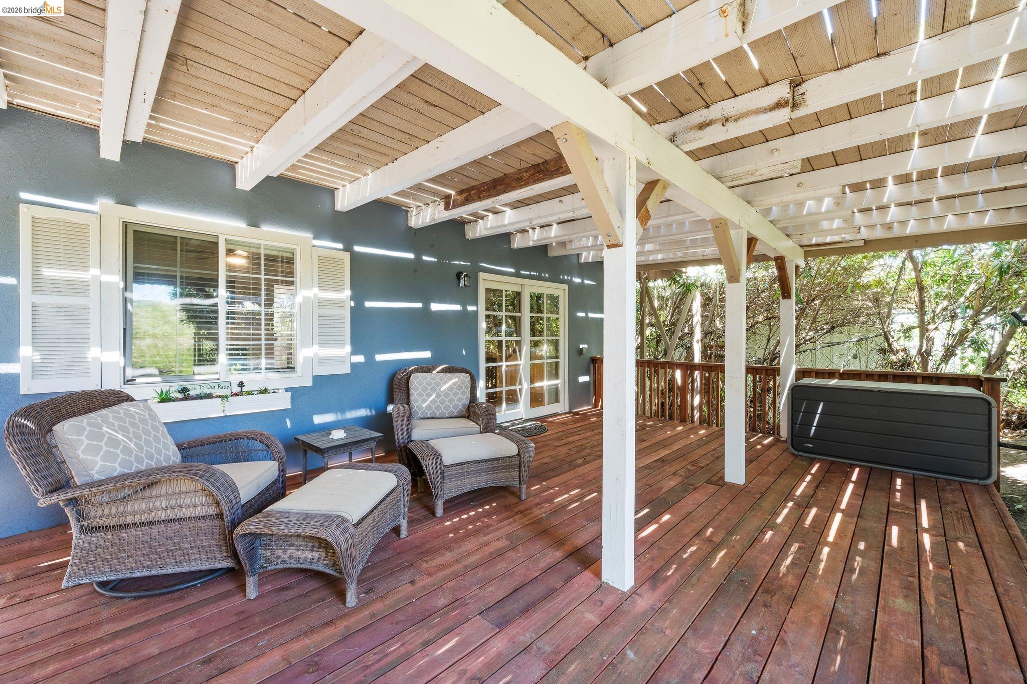 1704 Taylor Road Bethel Island, CA 94511 - Photo 46 of 73 Expansive outdoor deck featuring a slat-covered patio roof, wood flooring, and white support beams