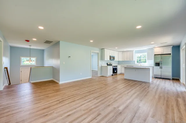 a view of a kitchen with wooden floor and a kitchen