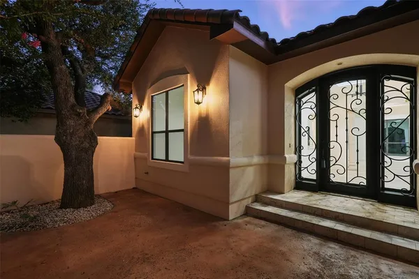 a view of a door and porch with furniture