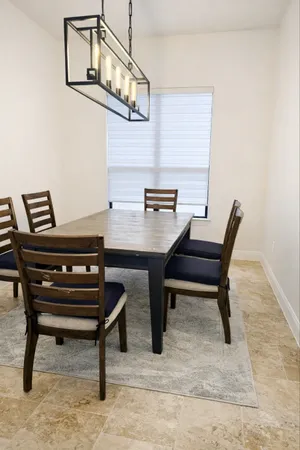 a living room with furniture and kitchen view