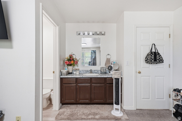 203 North Geneva Road, Unit 10 Provo, UT 84601 - Photo 7 of 30 Vanity area featuring a single basin, laminate countertop, and wood-finish cabinetry